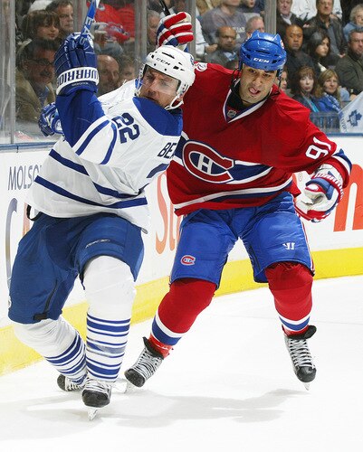 TORONTO - OCTOBER 1:  Scott Gomez #91 of the Montreal Canadiens grabs Francois Beauchemin #22 of the Toronto Maple Leafs in the Maple Leafs' home opener on October 1, 2009 at the Air Canada Centre in Toronto, Ontario. The Canadiens dfeated the Leafs 4-3 in overtime. <br /><br /><span class="help">(Photo by Claus Andersen/Getty Images)</span>