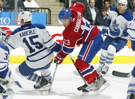 TORONTO - OCTOBER 1:  Mike Cammallari #13 of the Montreal Canadiens battles with Tomas Kaberle #15 of the Toronto Maple Leafs in the Maple Leafs' home opener on October 1, 2009 at the Air Canada Centre in Toronto, Ontario. The Canadiens defeated the Leafs 4-3 in overtime. <br /><br /><span class="help">(Photo by Claus Andersen/Getty Images)</span>
