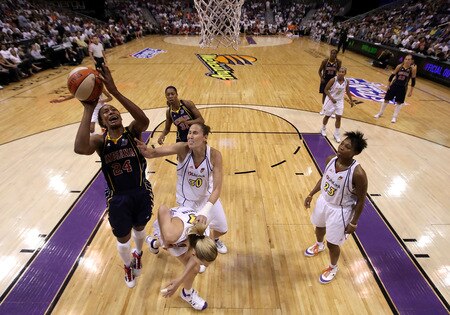 PHOENIX - OCTOBER 01:  Tamika Catchings #24 of the Indiana Fever lays up a shot past Nicole Ohlde #30 of the Phoenix Mercury in Game Two of the 2009 WNBA Finals at US Airways Center on October 1, 2009 in Phoenix, Arizona. The Fever defeated the Mercury 94-83 to tie the series at 1-1. <br /><br /><span class="help">(Photo by Christian Petersen/Getty Images)</span>
