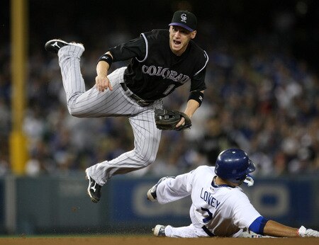LOS ANGELES - OCTOBER 3:   Shortstop Clint Barmes #12 of the Colorado Rockies watches his throw to first to turn the double play as he jumps over James Loney #7 of the Los Angeles Dodgers on October 3, 2009 at Dodger Stadium in Los Angeles, California.   <br /><br /><span class="help">(Photo by Stephen Dunn/Getty Images)</span>