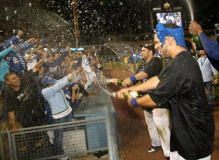 LOS ANGELES, CA - OCTOBER 03:  James Loney #7 (R) and Russell Martin #55 of the Los Angeles Dodgers spray champagne on fans as they celebrate after the game with the Colorado Rockies on October 3, 2009 at Dodger Stadium in Los Angeles, California.  The Dodgers won 5-0 to clinch the National League West.  <br /><br /><span class="help">(Photo by Stephen Dunn/Getty Images)</span>