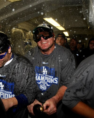 LOS ANGELES, CA - OCTOBER 03:  Jim Thome #25 of the Los Angeles Dodgers celebrates as champagne sprays in the locker room after the game with the Colorado Rockies on October 3, 2009 at Dodger Stadium in Los Angeles, California.  The Dodgers won 5-0 to clinch the National League West.  <br /><br /><span class="help">(Photo by Stephen Dunn/Getty Images)</span>