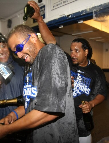LOS ANGELES - OCTOBER 3:  Manny Ramirez #99 (R) of the Los Angeles Dodgers pours champagne on the head of Matt Kemp #27 as they celebrate after the game with the Colorado Rockies on October 3, 2009 at Dodger Stadium in Los Angeles, California.  The Dodgers won 5-0 to clinch the National League West.  <br /><br /><span class="help">(Photo by Stephen Dunn/Getty Images)</span>