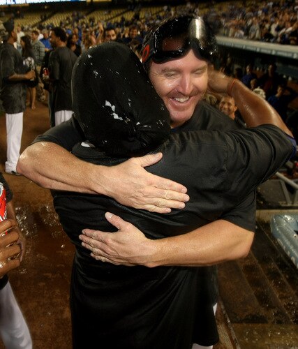 LOS ANGELES, CA - OCTOBER 03:    Jim Thome #25 of the Los Angeles Dodgers hugs Manny Ramirez #99 as they celebrate after the game with the Colorado Rockies on October 3, 2009 at Dodger Stadium in Los Angeles, California.  The Dodgers won 5-0 to clinch the National League West.  <br /><br /><span class="help">(Photo by Stephen Dunn/Getty Images)</span>