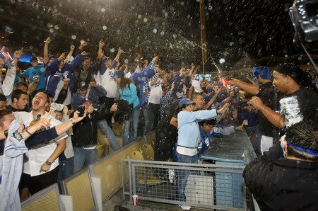 LOS ANGELES, CA - OCTOBER 03:  Manny Ramirez #99 of the Los Angeles Dodgers and teammates spray champagne on fans as they celebrate after the game with the Colorado Rockies on October 3, 2009 at Dodger Stadium in Los Angeles, California.  The Dodgers won 5-0 to clinch the National League West.  <br /><br /><span class="help">(Photo by Stephen Dunn/Getty Images)</span>