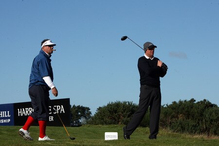 CARNOUSTIE, SCOTLAND - OCTOBER 04:  Shane Warne of Australia watched by Sir Ian Botham of England on the tee at the 15th hole during the third round of the Alfred Dunhill Links Championship at Carnoustie Golf Links on October 4, 2009 in Carnoustie, Scotland. The third round was postponed on saturday due to gale force winds.  <br /><br /><span class="help">(Photo by David Cannon/Getty Images)</span>