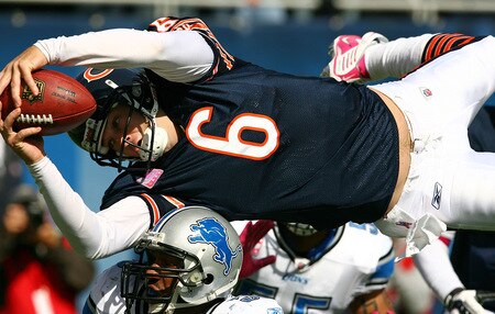 CHICAGO - OCTOBER 04: Jay Cutler #6 of the Chicago Bears leaps over Julian Peterson #59 of the Detroit Lions to score a touchdown in the first quarter on October 4, 2009 at Soldier Field in Chicago, Illinois.  <br /><br /><span class="help">(Photo by Jonathan Daniel/Getty Images)</span>
