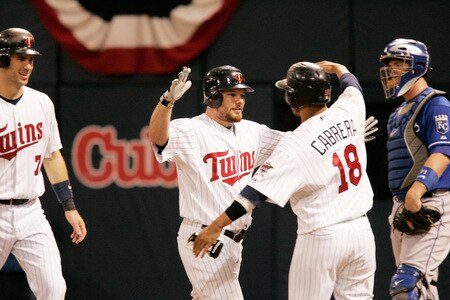 MINNEAPOLIS, MN - OCTOBER 4: Jason Kubel #16 of the Minnesota Twins celebrates with teammate Orlando Cabrera #18 as Joe Mauer #7 looks on after hitting a three-run home run against the Kansas City Royals in the third inning at Hubert H. Humphrey Metrodome on October 4, 2009 in Minneapolis, Minnesota.  Kubel also hit a three-run home run in the first inning during the Twins' last regular season game at the Dome. <br /><br /><span class="help">(Photo by Genevieve Ross/Getty Images)</span>