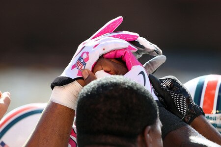 MIAMI - OCTOBER 04:  Miami Dolphins players where pink gloves for the NFL's 'A Crucial Catch",  in salute to breast cancer awareness month before taking on the Buffalo Bills at Land Shark Stadium on October 4, 2009 in Miami, Florida.  <br /><br /><span class="help">(Photo by Doug Benc/Getty Images)</span>