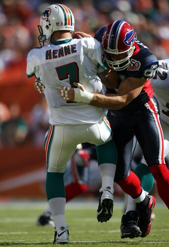 MIAMI - OCTOBER 04: Quarterback Chad Henne #7 of the Miami Dolphins is sacked by defensive end Chris Kelsay #90 of the Buffalo Bills at Land Shark Stadium on October 4, 2009 in Miami, Florida.  <br /><br /><span class="help">(Photo by Marc Serota/Getty Images)</span>