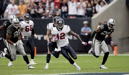 HOUSTON - OCTOBER 04:  Jacoby Jones #12 of the Houston Texans returns a free kick for 95 yards for a touchdown in the third quarter as Stanford Routt #26 and Tony Stewert #86 of the Oakland Raiders can't make the tackle at Reliant Stadium on October 4, 2009 in Houston, Texas.  <br /><br /><span class="help">(Photo by Bob Levey/Getty Images)</span>