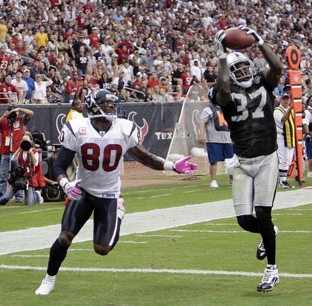HOUSTON - OCTOBER 04:  Cornerback Chris Johnson #37 of the Oakland Raiders intercepts a pass intended for wide receiver Andre Johnson #80 of the Houston Texans in the first half at Reliant Stadium on October 4, 2009 in Houston, Texas.  <br /><br /><span class="help">(Photo by Bob Levey/Getty Images)</span>
