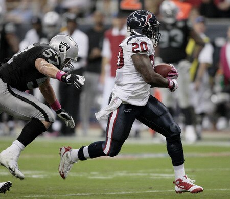 HOUSTON - OCTOBER 04:  Running back Steve Slaton #20 of the Houston Texans slips past linebacker Ricky Brown #57 scores on a 32 yard run in the second quarter against the Oakland Raiders at Reliant Stadium on October 4, 2009 in Houston, Texas.  <br /><br /><span class="help">(Photo by Bob Levey/Getty Images)</span>