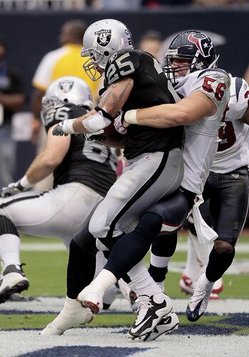 HOUSTON - OCTOBER 04:  Linebacker Brian Cushing #56 of the Houston Texans tackles  running back Justin Fargas #25 of the Oakland Raiders in the end-zone for a safety at Reliant Stadium on October 4, 2009 in Houston, Texas.  <br /><br /><span class="help">(Photo by Bob Levey/Getty Images)</span>