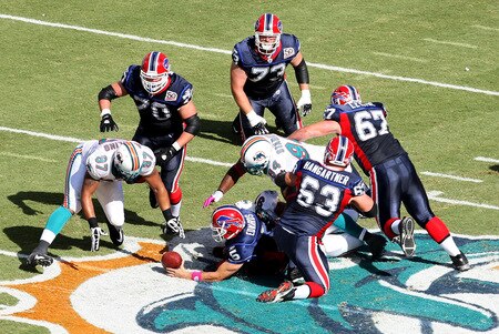 MIAMI - OCTOBER 04:  Quarterback Trent Edwards #5 of the Buffalo Bills fumbles the ball after being sacked by defensive end Randy Starks #94 of the Miami Dolphins at Land Shark Stadium on October 4, 2009 in Miami, Florida.  <br /><br /><span class="help">(Photo by Doug Benc/Getty Images)</span>