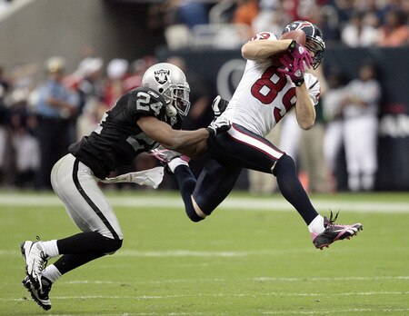 HOUSTON - OCTOBER 04:  Wide receiver David Anderson #89 of the Houston Texans completes a reception in front of safety Michael Huff #24 of the Oakland Raiders at Reliant Stadium on October 4, 2009 in Houston, Texas.  <br /><br /><span class="help">(Photo by Bob Levey/Getty Images)</span>