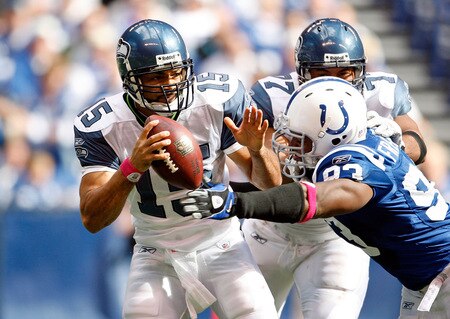 INDIANAPOLIS - OCTOBER 04:  Seneca Wallace #15 of the Seattle Seahawks is sacked by Dwight Freeney #93 of the Indianapolis Colts during the NFL game against  at Lucas Oil Stadium on October 4, 2009 in Indianapolis, Indiana.  <br /><br /><span class="help">(Photo by Andy Lyons/Getty Images)</span>