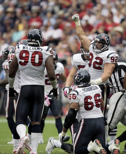 HOUSTON - OCTOBER 04:  Defensive tackle Jeff Zgonina #92 of the Houston Texans celebrates with Mario Williams #90 and DelJaun Robinson #66 after making a big tackle in the fourth quarter at Reliant Stadium on October 4, 2009 in Houston, Texas.  <br /><br /><span class="help">(Photo by Bob Levey/Getty Images)</span>