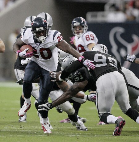 HOUSTON - OCTOBER 04:  Running back Steve Slaton #20 of the Houston Texans pushes aside defensive end Greg Ellis #99 and defensive tackle Gerard Warren #61 of the Oakland Raiders Houston Texans pushes aside defensive end Gre at Reliant Stadium on October 4, 2009 in Houston, Texas.  <br /><br /><span class="help">(Photo by Bob Levey/Getty Images)</span>
