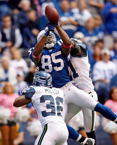 INDIANAPOLIS - OCTOBER 04:  Pierre Garcon #85 of the Indianapolis Colts reaches up for the ball while defended by Kelly Jennings #21 of the Seattle Seahawks at Lucas Oil Stadium on October 4, 2009 in Indianapolis, Indiana. The Colts won 34-17.  <br /><br /><span class="help">(Photo by Andy Lyons/Getty Images)</span>