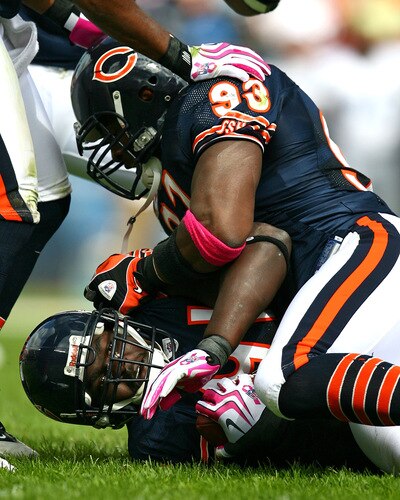 CHICAGO - OCTOBER 04: Adewale Ogunleye #93 of the Chicago Bears jumps on teammate Tommie Harris #91 after Harris intercepted a pass against the Detroit Lions on October 4, 2009 at Soldier Field in Chicago, Illinois. The Bears defeated the Lions 48-24. <br /><br /><span class="help">(Photo by Jonathan Daniel/Getty Images)</span>