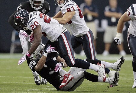HOUSTON - OCTOBER 04:  Running back Steve Slaton #20 of the Houston Texans runs over safety Tyvon Branch #33 of the Oakland Raiders at Reliant Stadium on October 4, 2009 in Houston, Texas.  <br /><br /><span class="help">(Photo by Bob Levey/Getty Images)</span>