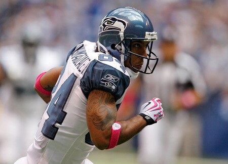 INDIANAPOLIS - OCTOBER 04:  T.J. Houshmandzadeh #84 of the Seattle Seahawks runs with the ball during the NFL game against the Indianapolis Colts at Lucas Oil Stadium on October 4, 2009 in Indianapolis, Indiana. Many players and officials in the NFL wore pink as part of breast cancer awareness month.  <br /><br /><span class="help">(Photo by Andy Lyons/Getty Images)</span>