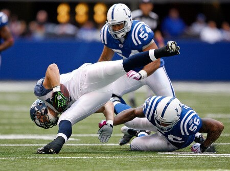 INDIANAPOLIS - OCTOBER 04:  Owen Schmitt #35 of the Seattle Seahawks is tripped up by Tyjuan Hagler #56 of the Indianapolis Colts during the NFL game at Lucas Oil Stadium on October 4, 2009 in Indianapolis, Indiana.  <br /><br /><span class="help">(Photo by Andy Lyons/Getty Images)</span>