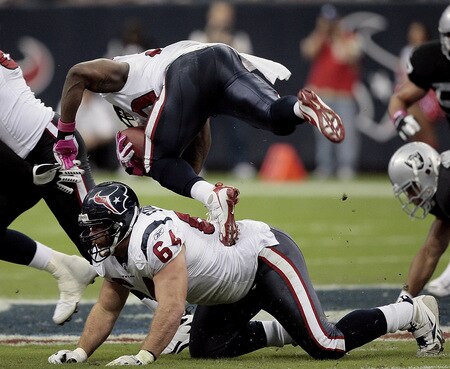HOUSTON - OCTOBER 04:  Running back Steve Slaton #20 of the Houston Texans trips over guard Kasey Studdard #64 at Reliant Stadium on October 4, 2009 in Houston, Texas.  <br /><br /><span class="help">(Photo by Bob Levey/Getty Images)</span>