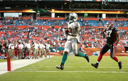 MIAMI - OCTOBER 04:  Running back Ronnie Brown #23 of the Miami Dolphins scores a fourth quarter touchdown past safety George Wilson #37 of the Buffalo Bills at Land Shark Stadium on October 4, 2009 in Miami, Florida. The Dolphins defeated the Bills 38-10.  <br /><br /><span class="help">(Photo by Doug Benc/Getty Images)</span>