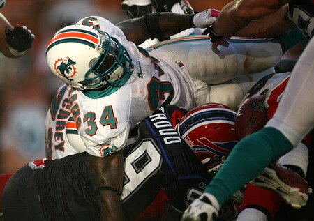 MIAMI - OCTOBER 04:  Running back Ricky Williams #34 of the Miami Dolphins fumbles the ball but recovered in the end-zone for a touchdown against the Buffalo Bills at Land Shark Stadium on October 4, 2009 in Miami, Florida. The Dolphins defeated the Bills 38-10.  <br /><br /><span class="help">(Photo by Doug Benc/Getty Images)</span>