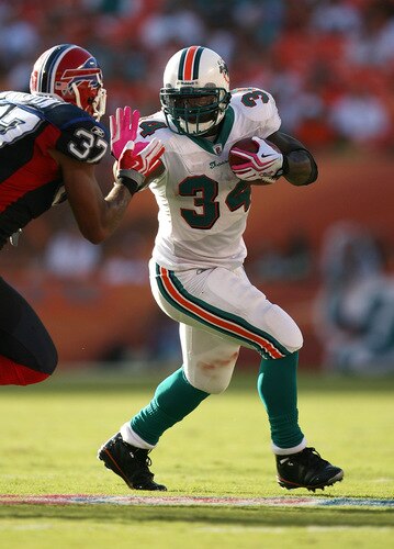 MIAMI - OCTOBER 04:  Running back Ricky Williams #34 of the Miami Dolphins stiff-arms George Wilson #37 of the Buffalo Bills at Land Shark Stadium on October 4, 2009 in Miami, Florida. The Dolphins defeated the Bills 38-10.  <br /><br /><span class="help">(Photo by Doug Benc/Getty Images)</span>