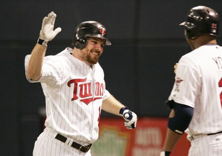 MINNEAPOLIS, MN - OCTOBER 4: Jason Kubel #16 of the Minnesota Twins celebrates with teammate Delmon Young #21 after hitting a three-run home run against the Kansas City Royals in the third inning at Hubert H. Humphrey Metrodome on October 4, 2009 in Minneapolis, Minnesota. <br /><br /><span class="help">(Photo by Genevieve Ross/Getty Images)</span>