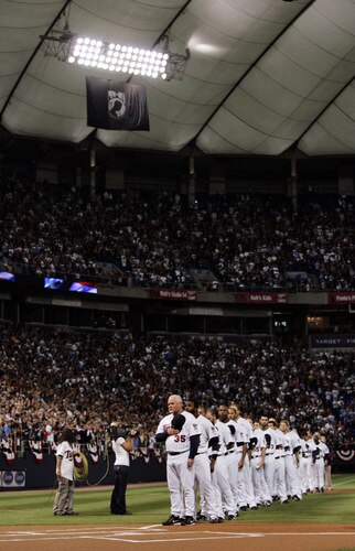 MINNEAPOLIS, MN - OCTOBER 4: Members of the Minnesota Twins line up for the National Anthem before the start of their game against the Kansas City Royals during their last regular season game at Hubert H. Humphrey Metrodome on October 4, 2009 in Minneapolis, Minnesota. <br /><br /><span class="help">(Photo by Genevieve Ross/Getty Images)</span>