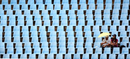 CENTURION, SOUTH AFRICA - OCTOBER 05: A cople of fans sit amongst empty seats during the ICC Champions Trophy Final between Australia and New Zealand played at Supersport Park on October 5, 2009 in Centurion, South Africa.  <br /><br /><span class="help">(Photo by Julian Herbert/Getty Images)</span>