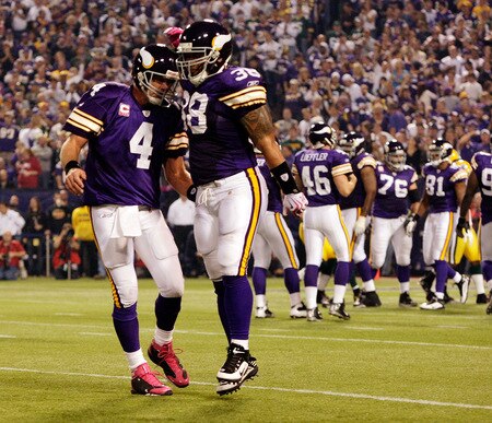 MINNEAPOLIS - OCTOBER 05:  Quarterback Brett Favre #4 of the Minnesota Vikings celebrates with Naufahu Tahi #38 after a touchdown during the game against the Green Bay Packers on October 5, 2009 at Hubert H. Humphrey Metrodome in Minneapolis, Minnesota.  <br /><br /><span class="help">(Photo by Jamie Squire/Getty Images)</span>