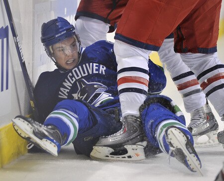 VANCOUVER, CANADA - OCTOBER 5: Mason Raymond #21 of the Vancouver Canucks gets tangled up and falls to the ice in the skates of the Columbus Blue Jackets during their game at General Motors Place October 5, 2009 in Vancouver, Canada.   <br /><br /><span class="help">(Photo by Nick Didlick/Getty Images)</span>
