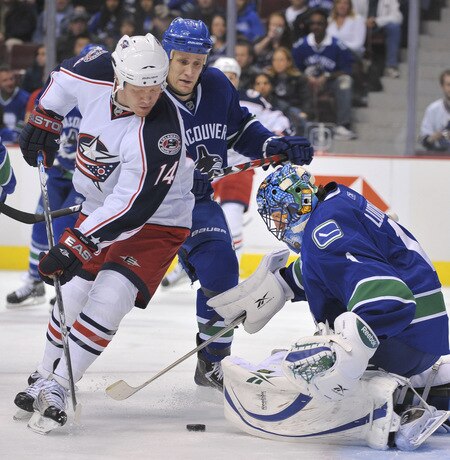 VANCOUVER, CANADA - OCTOBER 5: Raffi Torres #14 of the Columbus Blue Jackets tries to backhand the puck past Roberto Luongo #1 of the Vancouver Canucks while Sami Salo #6 of the Vancouver Canucks looks on during their game at General Motors Place October 5, 2009 in Vancouver, Canada.   <br /><br /><span class="help">(Photo by Nick Didlick/Getty Images)</span>