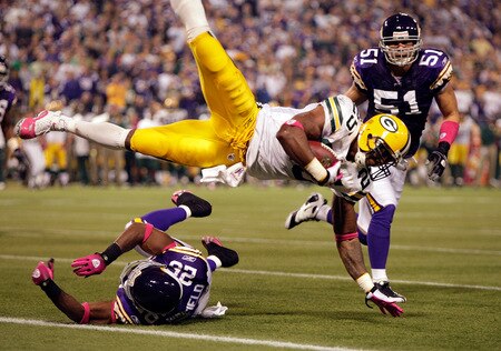 MINNEAPOLIS - OCTOBER 05:  Running back Ryan Grant #25 of the Green Bay Packers is upended by Antoine Winfield #26 of the Minnesota Vikings as Ben Leber #51 looks on during the Monday Night Football game on October 5, 2009 at Hubert H. Humphrey Metrodome in Minneapolis, Minnesota.  <br /><br /><span class="help">(Photo by Jamie Squire/Getty Images)</span>