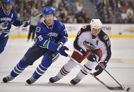 VANCOUVER, CANADA - OCTOBER 5: Mikael Samuelsson #26 of the Vancouver Canucks tries to steal the puck from R.J. Umberger #18 of the Columbus Blue Jackets during their game at General Motors Place October 5, 2009 in Vancouver, Canada.   <br /><br /><span class="help">(Photo by Nick Didlick/Getty Images)</span>