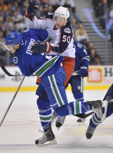 VANCOUVER, CANADA - OCTOBER 5: Antoine Vermette #50 of the Columbus Blue Jackets runs into Christian Ehrhoff #5 of the Vancouver Canucks during their game at General Motors Place October 5, 2009 in Vancouver, Canada.   <br /><br /><span class="help">(Photo by Nick Didlick/Getty Images)</span>