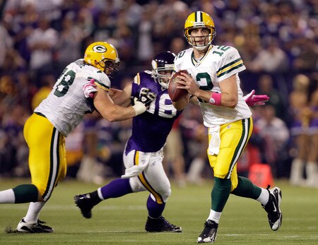 MINNEAPOLIS - OCTOBER 05:  Quarterback Aaron Rodgers #12 of the Green Bay Packers is chased by Brian Robinson #96 of the Minnesota Vikings during the Monday Night Football game on October 5, 2009 at Hubert H. Humphrey Metrodome in Minneapolis, Minnesota.  <br /><br /><span class="help">(Photo by Jamie Squire/Getty Images)</span>