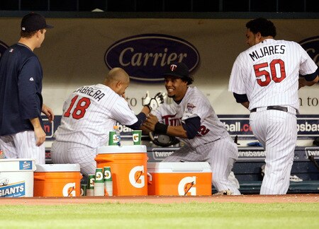 MINNEAPOLIS - OCTOBER 06:  Orlando Cabrera #18 of the Minnesota Twins dances in the dugout with Carlos Gomez #22 after hitting  a home run off the Detroit Tigers during the 7th inning of the American League Tiebreaker game on October 6, 2009 at Hubert H. Humphrey Metrodome in Minneapolis, Minnesota.  <br /><br /><span class="help">(Photo by Jamie Squire/Getty Images)</span>