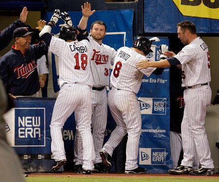 MINNEAPOLIS - OCTOBER 06:  Orlando Cabrera #18 of the Minnesota Twins is congratulated by teammates after hitting a home run off the Detroit Tigers during the 7th inning of the American League Tiebreaker game on October 6, 2009 at Hubert H. Humphrey Metrodome in Minneapolis, Minnesota.  <br /><br /><span class="help">(Photo by Jamie Squire/Getty Images)</span>