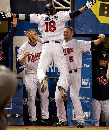 MINNEAPOLIS - OCTOBER 06:  Orlando Cabrera #18 of the Minnesota Twins is congratulated by teammates after hitting a home run against starting pitcher Rick Porcello # 48 of the Detroit Tigers during the 7th inning of the American League Tiebreaker game on October 6, 2009 at Hubert H. Humphrey Metrodome in Minneapolis, Minnesota.  <br /><br /><span class="help">(Photo by Jamie Squire/Getty Images)</span>