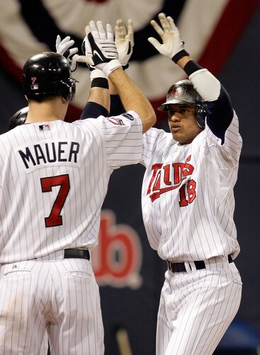 MINNEAPOLIS - OCTOBER 06:  Orlando Cabrera #18 of the Minnesota Twins is congratulated by teammates after hitting a home run off the Detroit Tigers during the 7th inning of the American League Tiebreaker game on October 6, 2009 at Hubert H. Humphrey Metrodome in Minneapolis, Minnesota.  <br /><br /><span class="help">(Photo by Jamie Squire/Getty Images)</span>