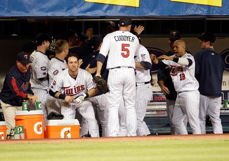 MINNEAPOLIS - OCTOBER 06:  Shortstop Orlando Cabrera #18 of the Minnesota Twins celebrates with teammates in the dugout following a double play during the 9th inningof the American League Tiebreaker game against the Detroit Tigers on October 6, 2009 at Hubert H. Humphrey Metrodome in Minneapolis, Minnesota.  <br /><br /><span class="help">(Photo by Jamie Squire/Getty Images)</span>