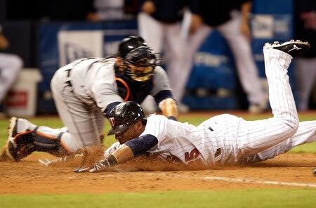 MINNEAPOLIS - OCTOBER 06:  Alexi Casilla #25 of the Minnesota Twins is tagged out at home plate by catcher Gerald Liard #8 of the Detroit Tigers in the bottom of the 10th inning during the American League Tiebreaker game on October 6, 2009 at Hubert H. Humphrey Metrodome in Minneapolis, Minnesota.  <br /><br /><span class="help">(Photo by Jamie Squire/Getty Images)</span>