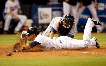 MINNEAPOLIS - OCTOBER 06:  Alexi Casilla #25 of the Minnesota Twins is tagged out at home plate by catcher Gerald Liard #8 of the Detroit Tigers in the bottom of the 10th inning during the American League Tiebreaker game on October 6, 2009 at Hubert H. Humphrey Metrodome in Minneapolis, Minnesota.  <br /><br /><span class="help">(Photo by Jamie Squire/Getty Images)</span>