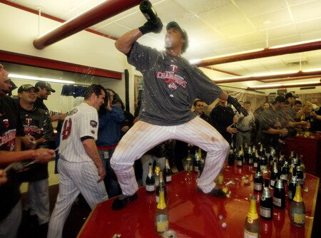MINNEAPOLIS - OCTOBER 06:  Carlos Gomez #22 of the Minnesota Twins celebrates with teammates in the locker room after the Twins defeated  the Detroit Tigers to win the American League Tiebreaker game on October 6, 2009 at Hubert H. Humphrey Metrodome in Minneapolis, Minnesota.  <br /><br /><span class="help">(Photo by Jamie Squire/Getty Images)</span>